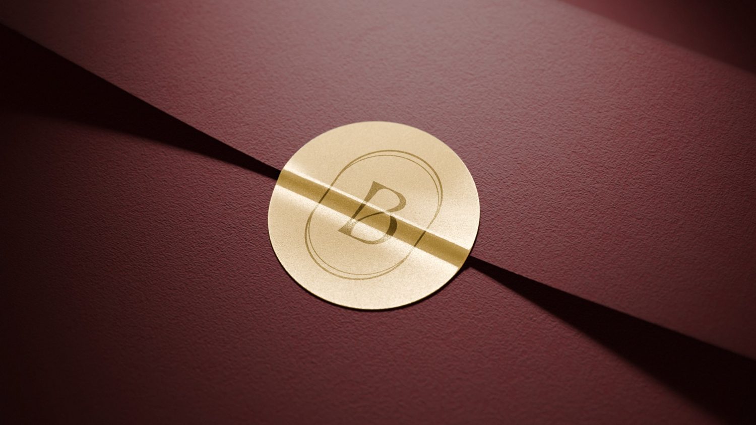 Burgundy Bodoá envelope with an embossed gold seal
