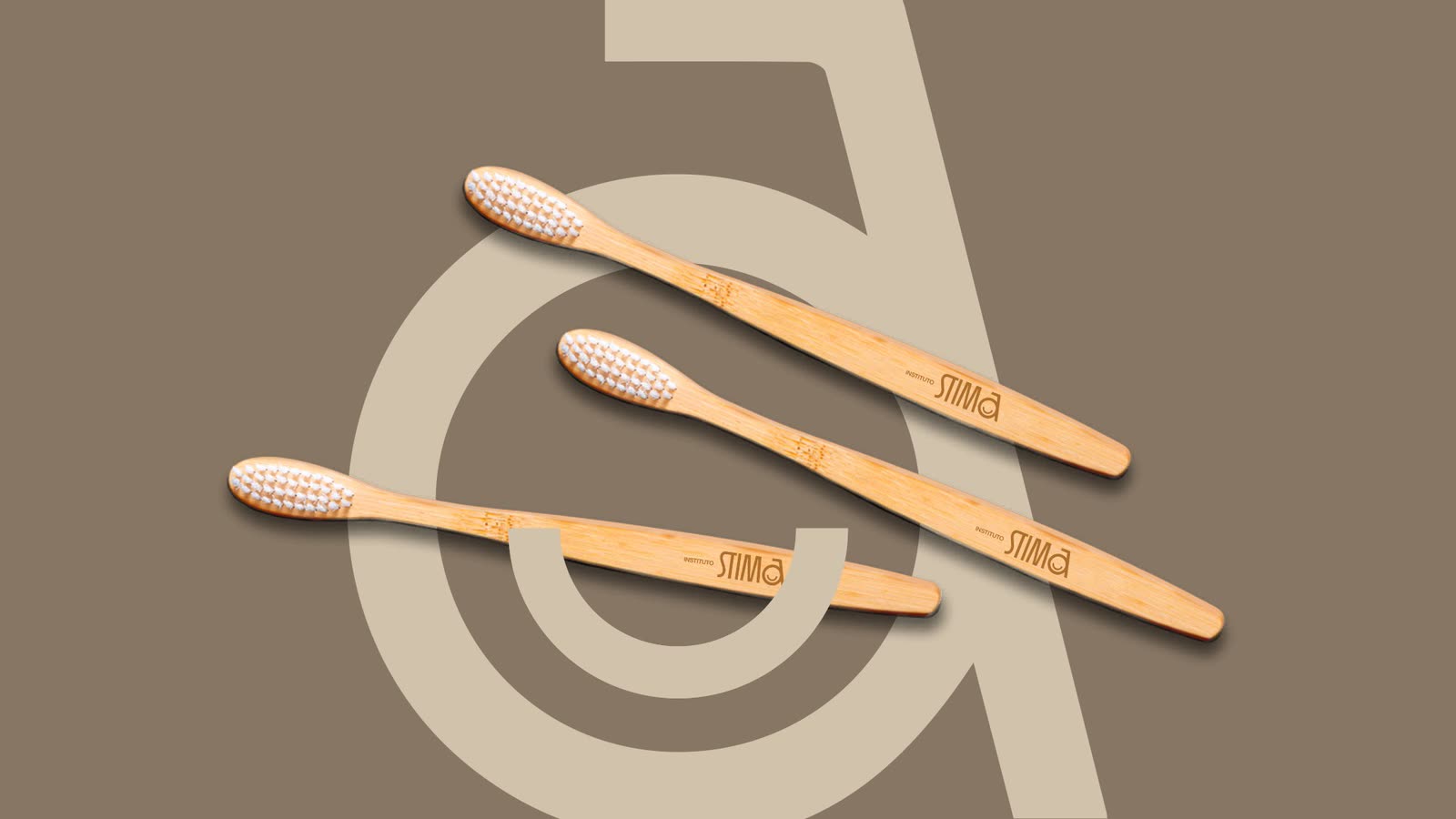 Bamboo toothbrushes with the STIMA logo over the a symbol