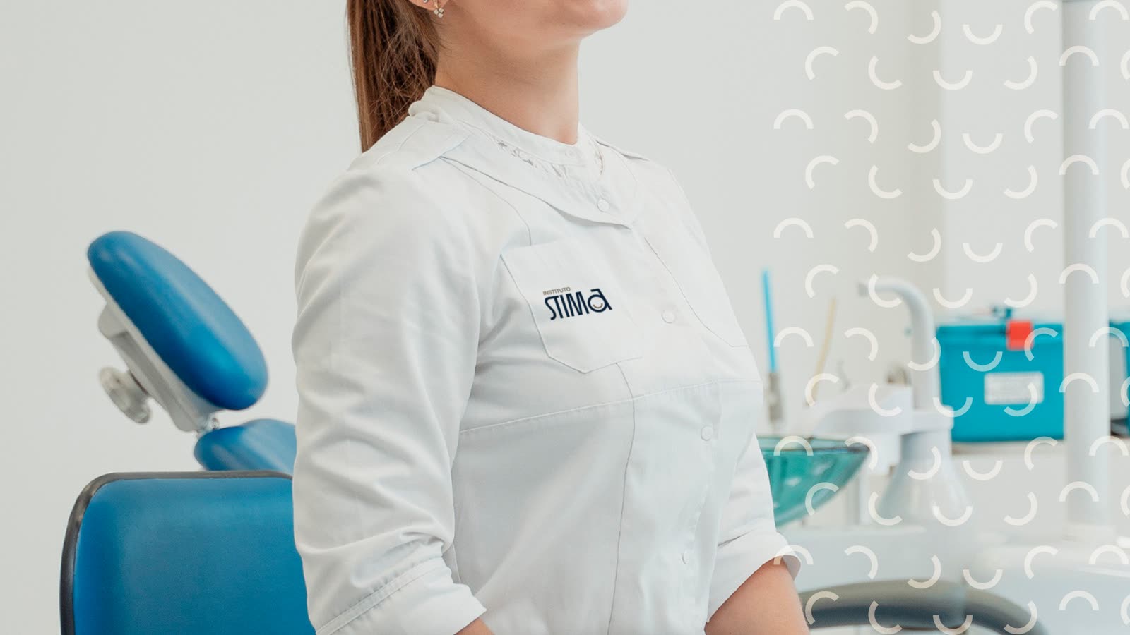A STIMA team member in a white uniform inside the clinic